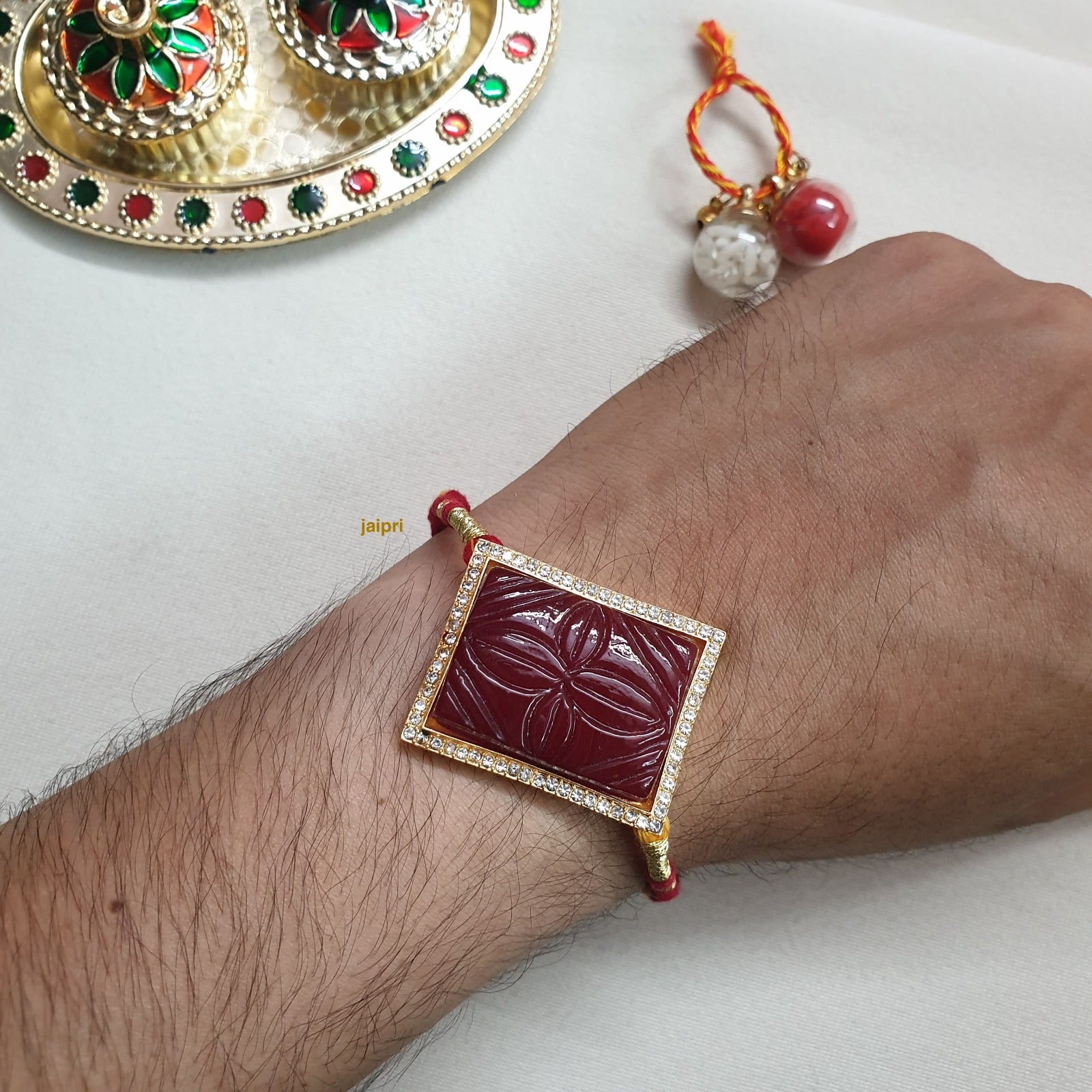Maroon Engraved Stone Rakhi