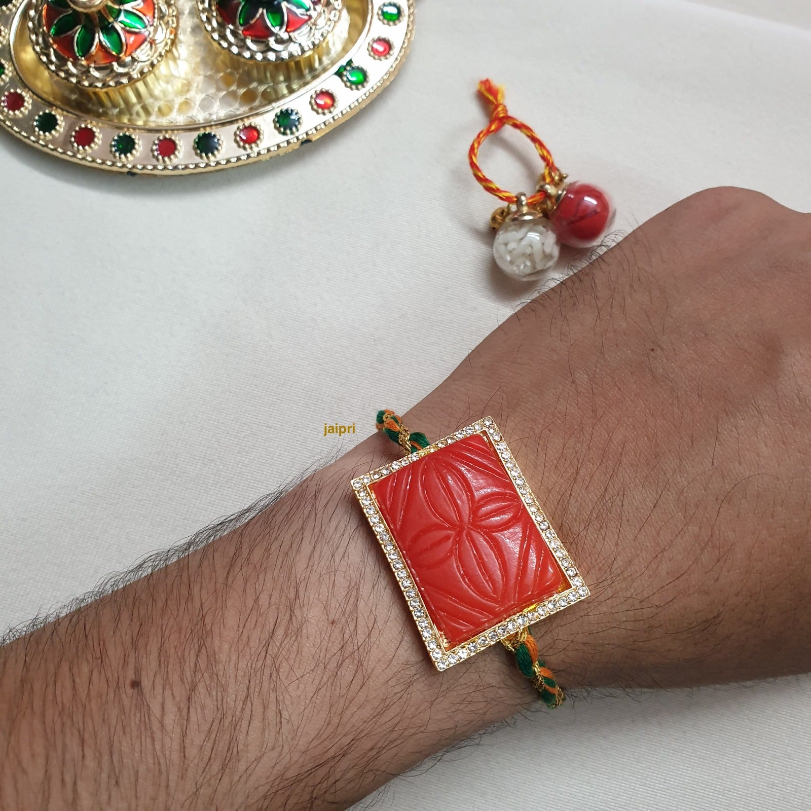 Orange Engraved Stone Rakhi