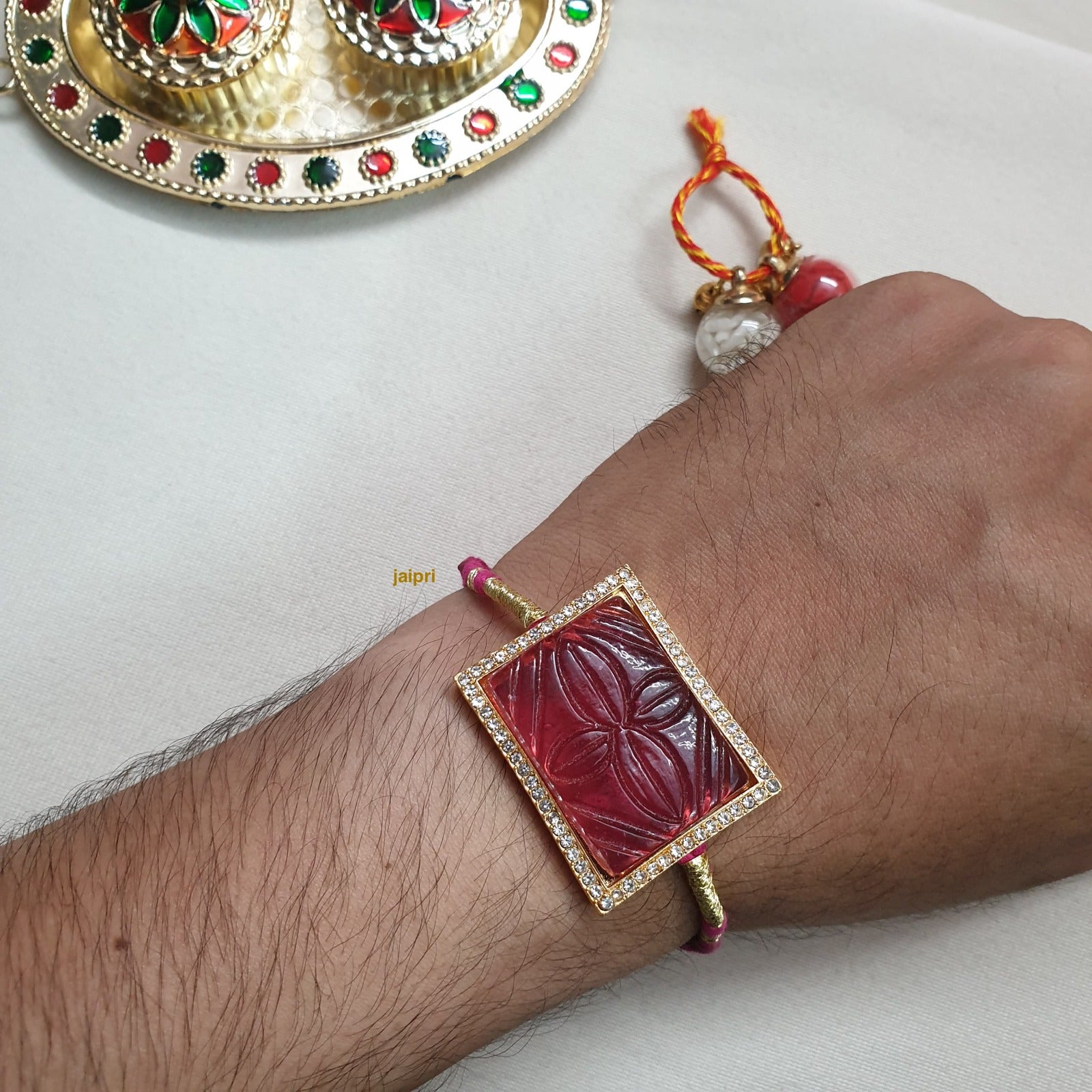 Pink Engraved Stone Rakhi