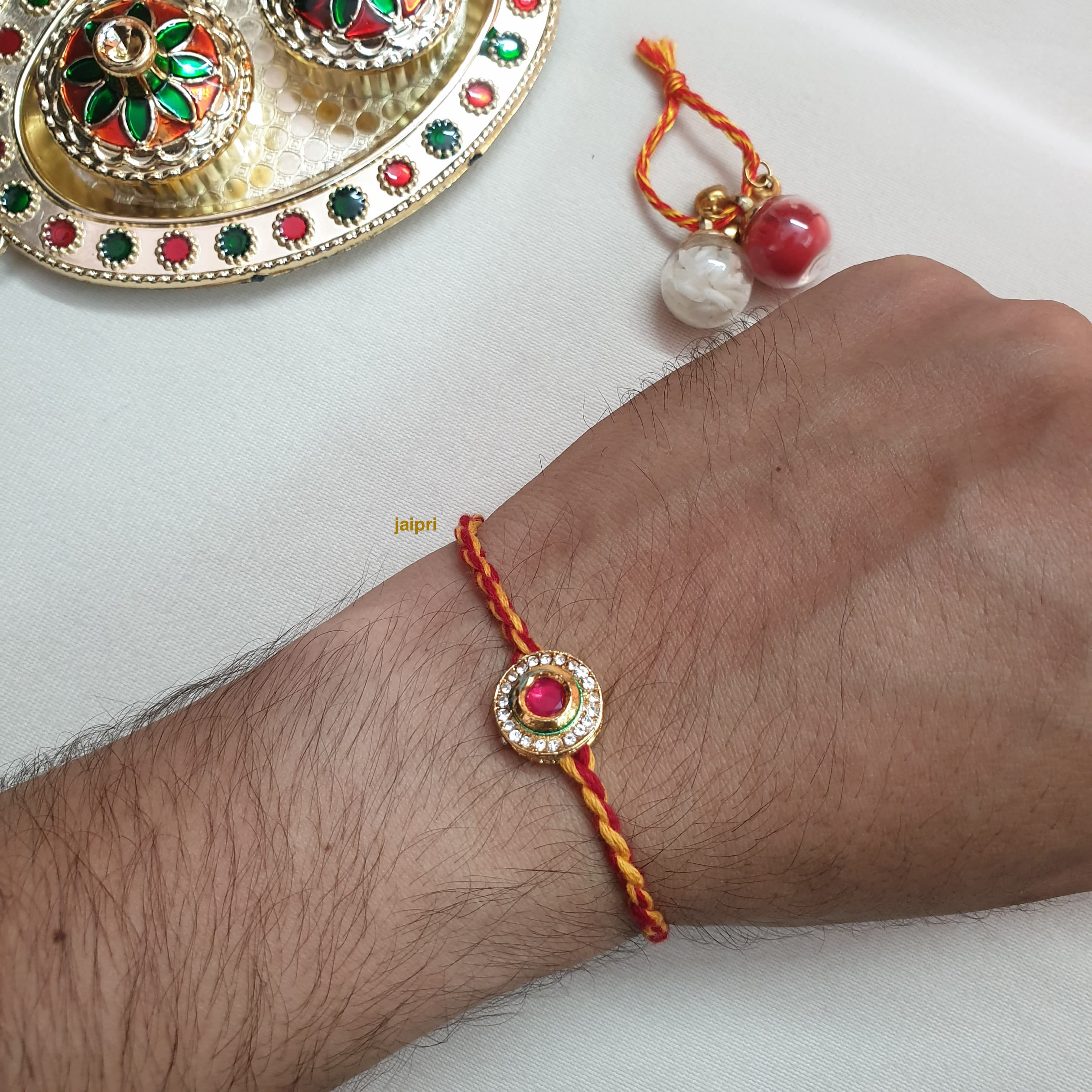 Gold Tone Red Stone Round Rakhi
