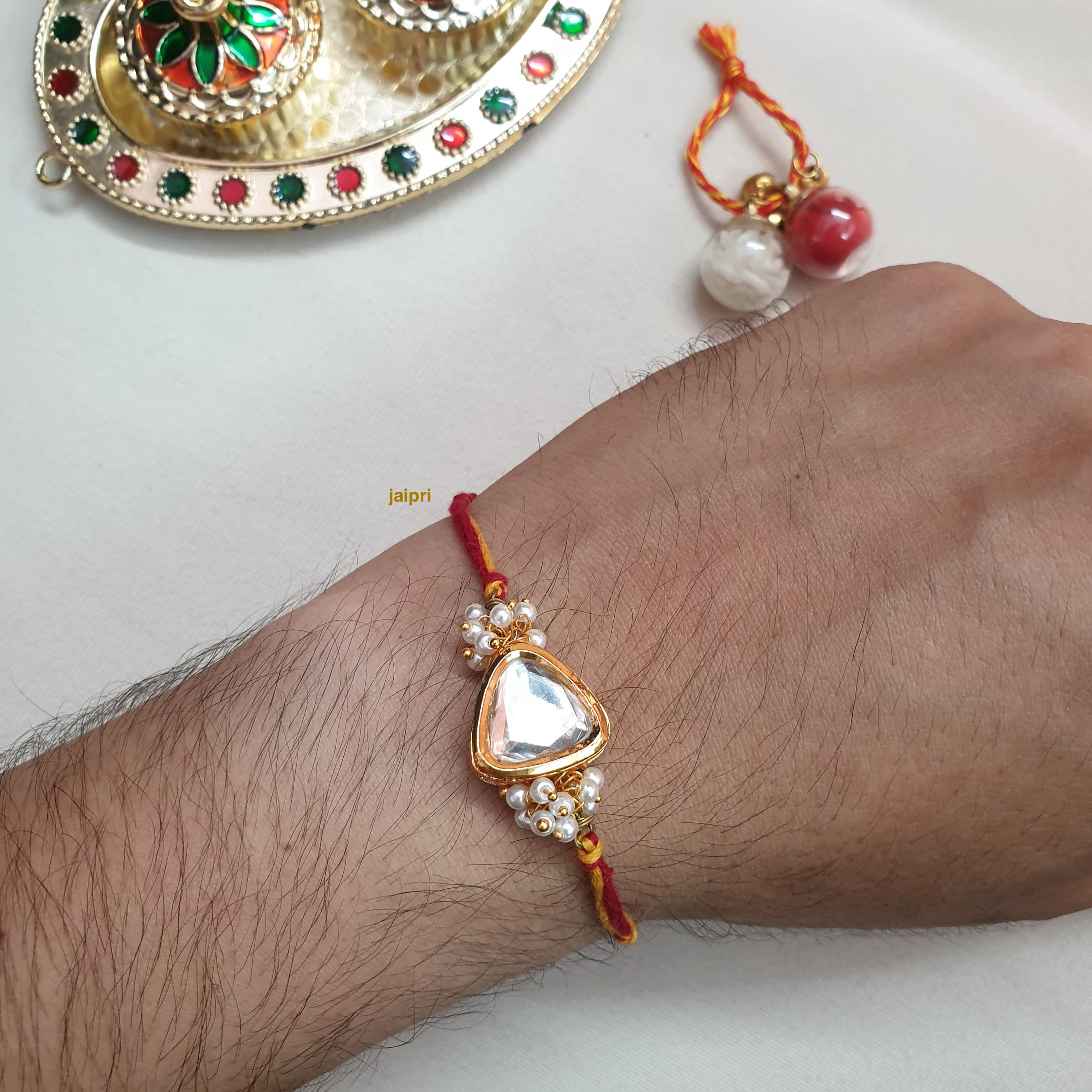 Gold Tone Triangle Kundan Rakhi